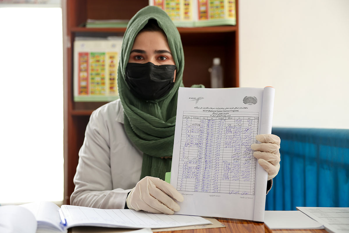 Dr Gulroy Safari registering patients on the waiting list for outpatient chemotherapy. Photo credit: WHO