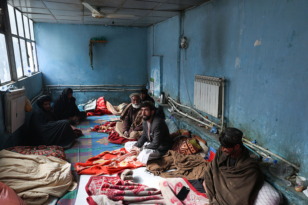 Male patients and their caregivers in a waiting area. Photo credit: WHO