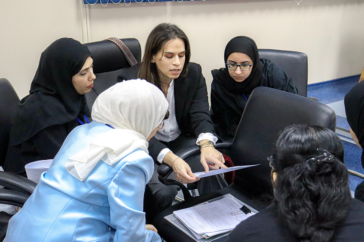 Participants review assessment tools and plan practical exercises. Photo credit: WHO / WHO Bahrain