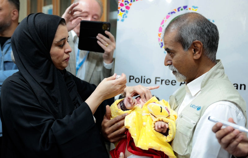 WHO Regional Director, Dr Hanan Balkhy with Sanjay Wijesekera, UNICEF Regional Director for South Asia, administering polio drops to a child during her their visit to Afghanistan.