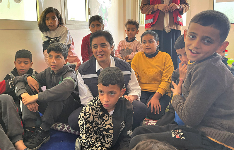 WHO Regional Director Dr Hanan Balkhy with children evacuated from Gaza being treated at Al-Arish Hospital in Egypt along with accompanying family members