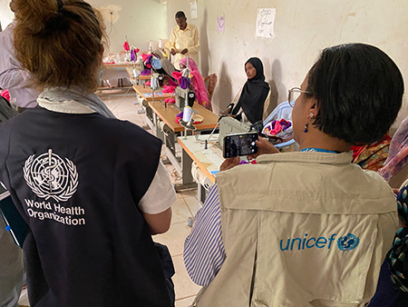 The Risk Communication and Community Engagement pillar member of WHO EMRO’s COVID-19 and other emergencies response review mission to Sudan and UNICEF Sudan counterpart visit a sewing workshop for reusable masks in Jabal Al-Awlyaa locality, Khartoum State, Sudan, 14 June 2022