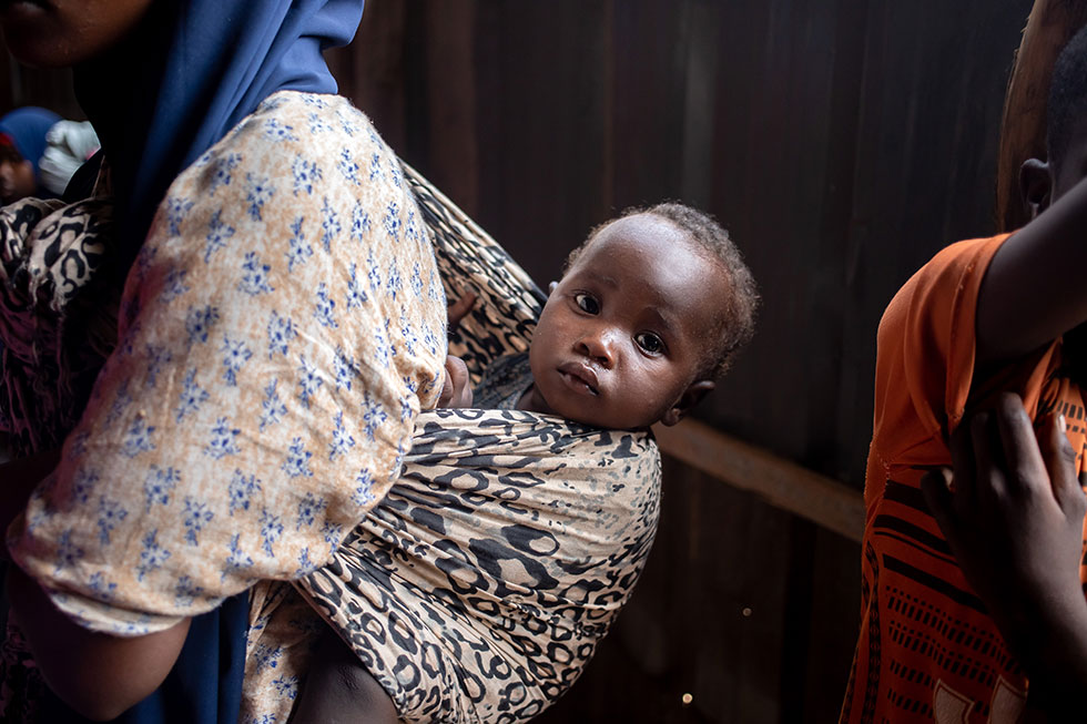 A child waits to receive vaccines during an integrated campaign, Mogadishu, 2022. Credit: WHO/Mukhtar Sudani/Ismail Taxte   